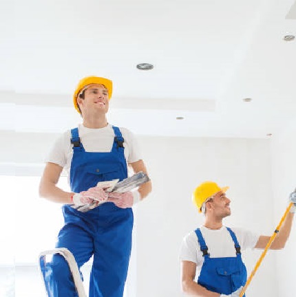 group of builders with tools indoors Key Qualities to Look for in a Painting Company