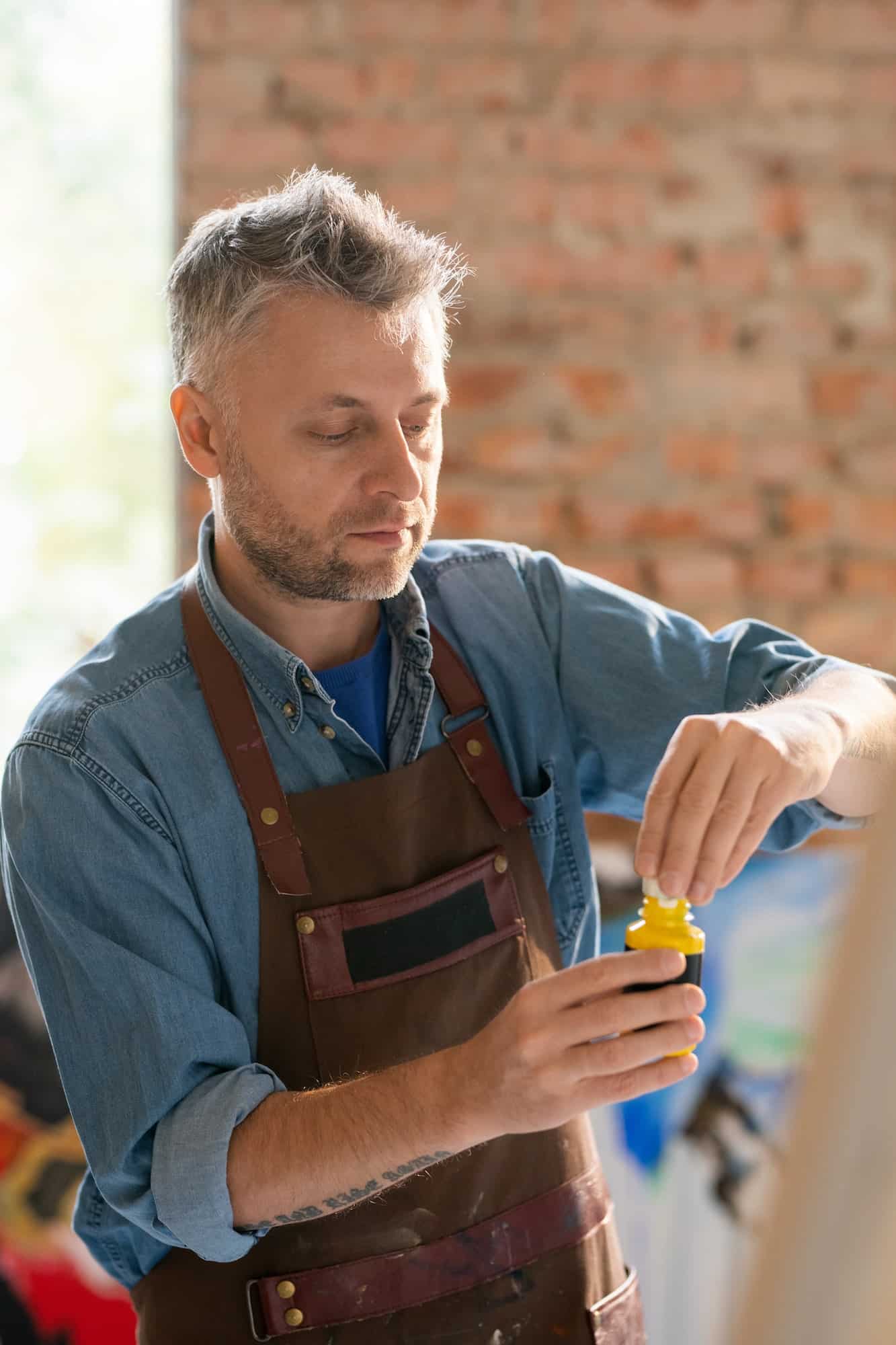 Professional painter preparing paint